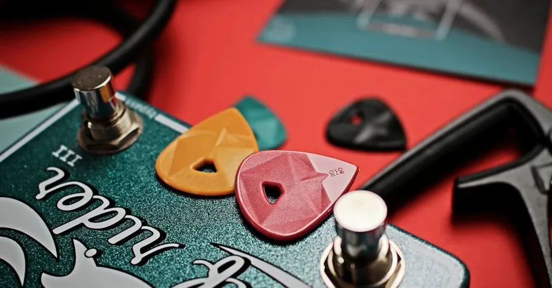 Close-up of colorful guitar picks on an electric effects pedal, showcasing vibrant musical accessories.
