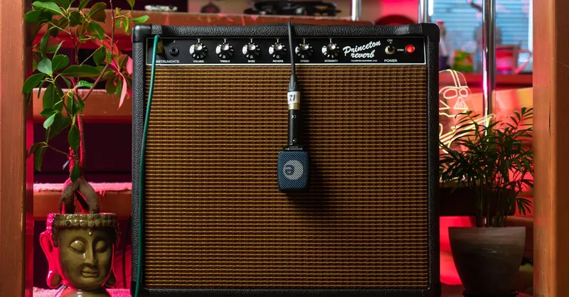 A retro combo amplifier with a microphone in a cozy indoor setting.