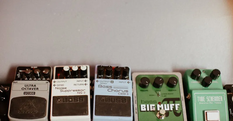 An assortment of guitar effects pedals including big muff and tube screamer.